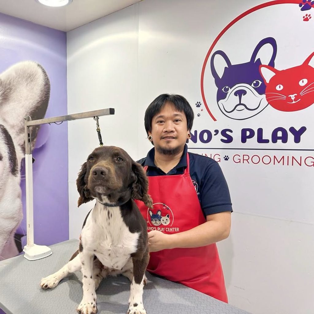 man holding dog for grooming